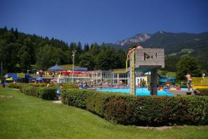 a large pool with a water park with a slide at Alpencamp Kärnten in Kötschach