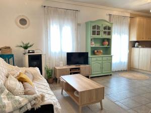 a living room with a couch and a tv at Apartamento La Plaza! in Bogarra