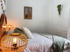 a bedroom with a bed with a bird cage on it at Apartamento La Plaza! in Bogarra