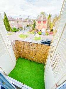 an open balcony with green grass on a street at Charming T2 Cozy close to Orly airport in Athis-Mons