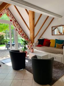 a living room with a couch and some chairs at La Bussière in La Bussière +3 photos