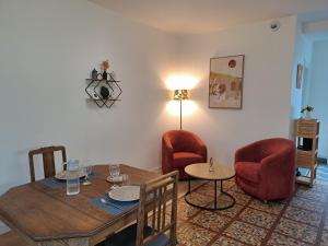 a dining room with a table and two chairs at Le Mosaïque, proche gare, terrasse, parking privé in Laval