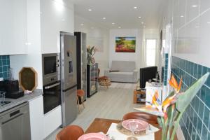 a kitchen and living room with a table and chairs at Casa do Frade in Abrantes