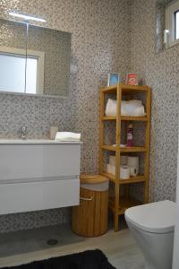 a bathroom with a sink and a toilet and a mirror at Casa do Frade in Abrantes +36 photos