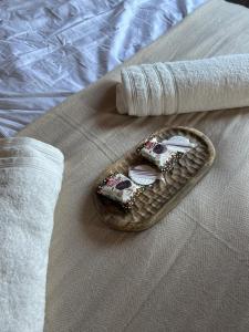a tray with two remote controls on a bed at Minimalist Cozy Apartment near Frankfurt in Altenstadt