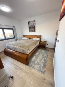 a bedroom with a bed and a rug at Luxurious Apt with Rooftop Pool in Dakar +54 photos