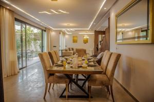 a dining room with a table and chairs at villa éden marrakech in Oulad Ikhia