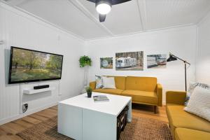 a living room with a couch and a tv at Sister Lakes Lakeside House - Sleeps 16 in Dowagiac