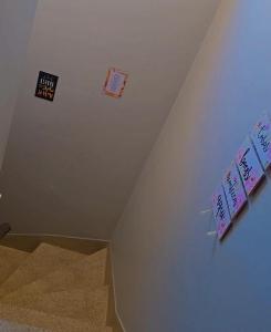 a room with some signs on the ceiling at Le house hostel in São Paulo
