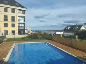 a swimming pool on the roof of a building at Hollyfoz Arenal in Foz