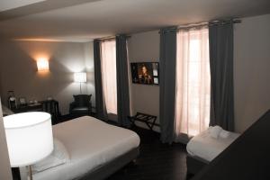 Rúm í herbergi á Hotel POZZO DI BORGO