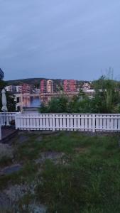 a white fence in front of a body of water at Worthwhile a visit in Porsgrunn +4 photos