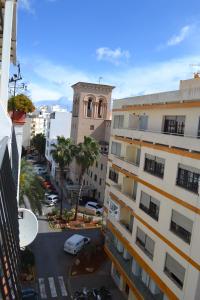 a city street with a large building at La Bartola Guesthouse in Ibiza Town