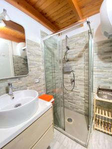 a bathroom with a sink and a shower at Costa Rei Panoramic Terrace- Free Parking- BBQ-Netflix in Costa Rei