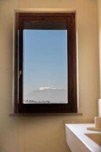 a bathroom window with a view of a mountain at La casa di Ernino in Tortoreto Lido +38 photos