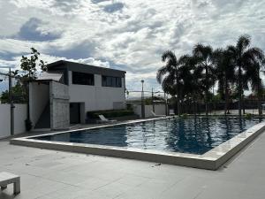 a large swimming pool in front of a house at Wand Apartment in Mactan Cebu International