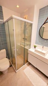 a bathroom with a shower and a toilet and a sink at Flat Muro Alto Ecolife in Porto De Galinhas