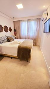 a bedroom with a bed and a window at Flat Muro Alto Ecolife in Porto De Galinhas +13 photos