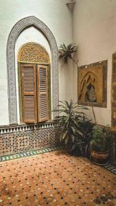 a room with a window and a tiled floor at Riad Kasbah in Rabat