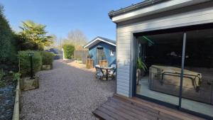 a house with a sliding glass door with a patio at Ô bonheur du paon in Arques
