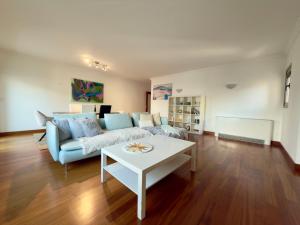 een woonkamer met een bank en een tafel bij Expo Luxury apartment in Lissabon
