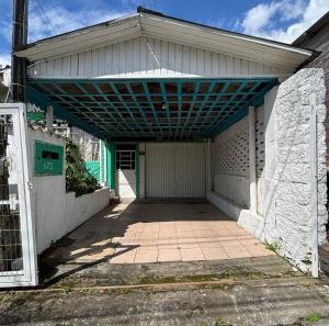 an empty garage with awning and a driveway at Casa Hospedes in Canela