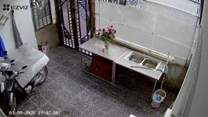 a small kitchen with a sink and a counter at Nhà du lịch nguyên căn in Khu Chi Lăng