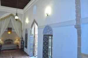 a room with white walls and a room with a bed at Riad Kasbah in Rabat