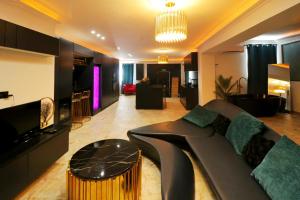 a living room with a couch and a table at OLGA Luxury Suite I 5 min from airport I central location I traditional village in Luqa
