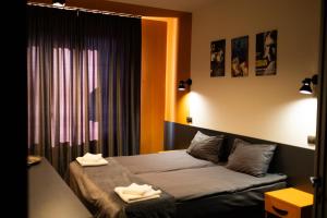 a bedroom with a bed with two towels on it at House Inn in Ivano-Frankivsʼk