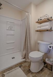a bathroom with a toilet and a shower at The Inn at Beulah Farm - The Barn in Whitley City