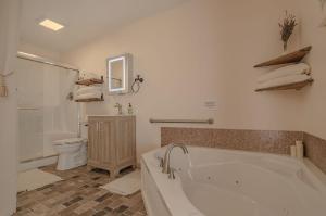 a bathroom with a bath tub and a toilet at The Inn at Beulah Farm - The Garden in Whitley City