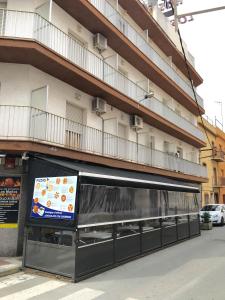 a building with avertisement for at Hostal Los Maños in Blanes