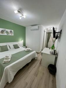 a bedroom with a bed and a desk with a television at Casa Vacanze Arcobaleno in Gasponi