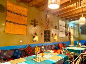 a dining room with tables and pillows on the wall at Auberge & Restaurant Agoudal in Agoudal +60 photos