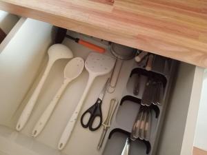 a drawer filled with utensils in a cabinet at Casa Maitén in El Bolsón