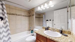 a bathroom with a sink and a toilet and a tub at Comfortable Family Friendly Home on Quincy Reservoir in Aurora