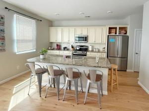 a kitchen with a large island with bar stools at Golf Resort, Beach, Entire House in Myrtle Beach