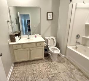 a bathroom with a toilet and a sink and a tub at Golf Resort, Beach, Entire House in Myrtle Beach