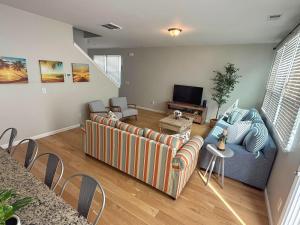 a living room with a couch and a tv at Golf Resort, Beach, Entire House in Myrtle Beach