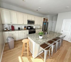 a kitchen with a large island with a counter top at Golf Resort, Beach, Entire House in Myrtle Beach +6 photos