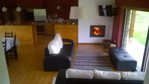 a living room with a couch and a fireplace at Quinta do Favacal - Agroturismo - Serra da Estrela in Casegas