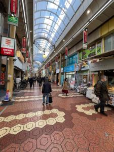 people walking through a shopping mall with a domed ceiling at 和風小筑と京町屋 in Tokyo