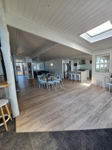 a large room with tables and chairs and a kitchen at Cygnets in Lake Munmorah +26 photos