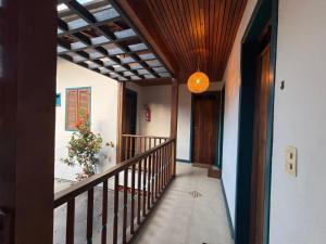 a hallway of a house with a staircase with a ceiling at Studio Hashi 08 in Paraty