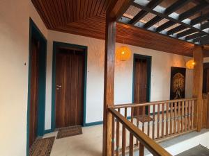 a hallway of a house with two doors and a staircase at Studio Hashi 08 in Paraty +13 photos