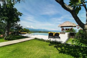 a backyard with a pool and a gazebo at Segara Gunung 3 Bedrooms Luxury Villa with Breathtaking Sea View in Temukus
