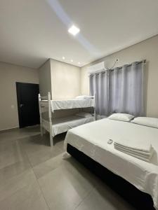 a hospital room with two beds and a window at LAR Espaço Lazer in Foz do Iguaçu +14 photos