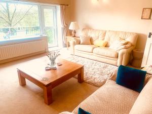 a living room with a couch and a coffee table at Tilly Cottage - overlooking Pendle Hill in Barrowford