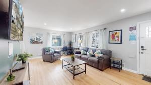 a living room with two couches and a table at Peaceful retreat in quite neighborhood in Denver